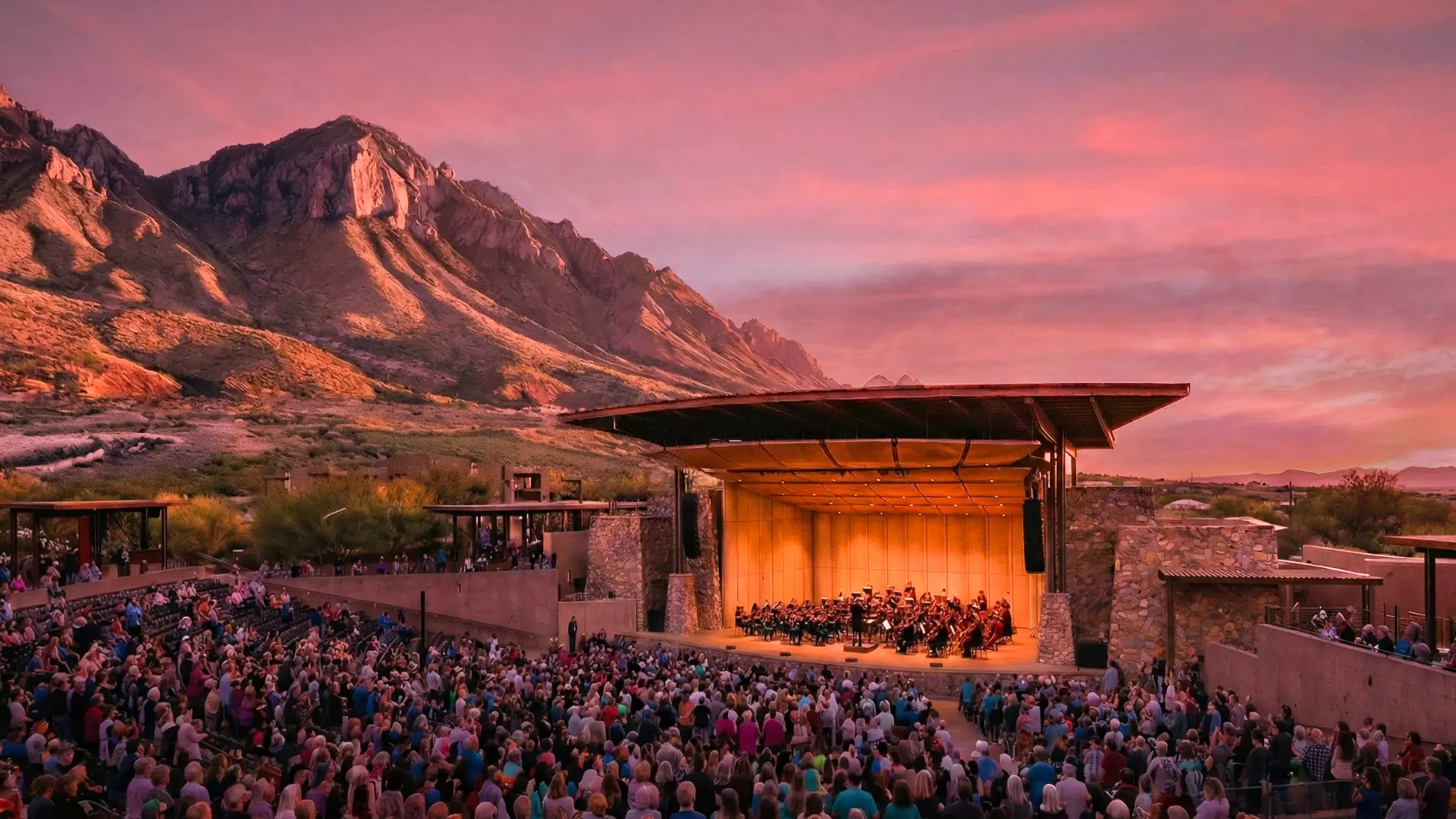 Rendering for the proposed Oro Valley Performing Arts Center with the Pusch Ridge Mountains in the background at sunset