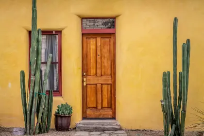 Yellow adobe house with wooden door